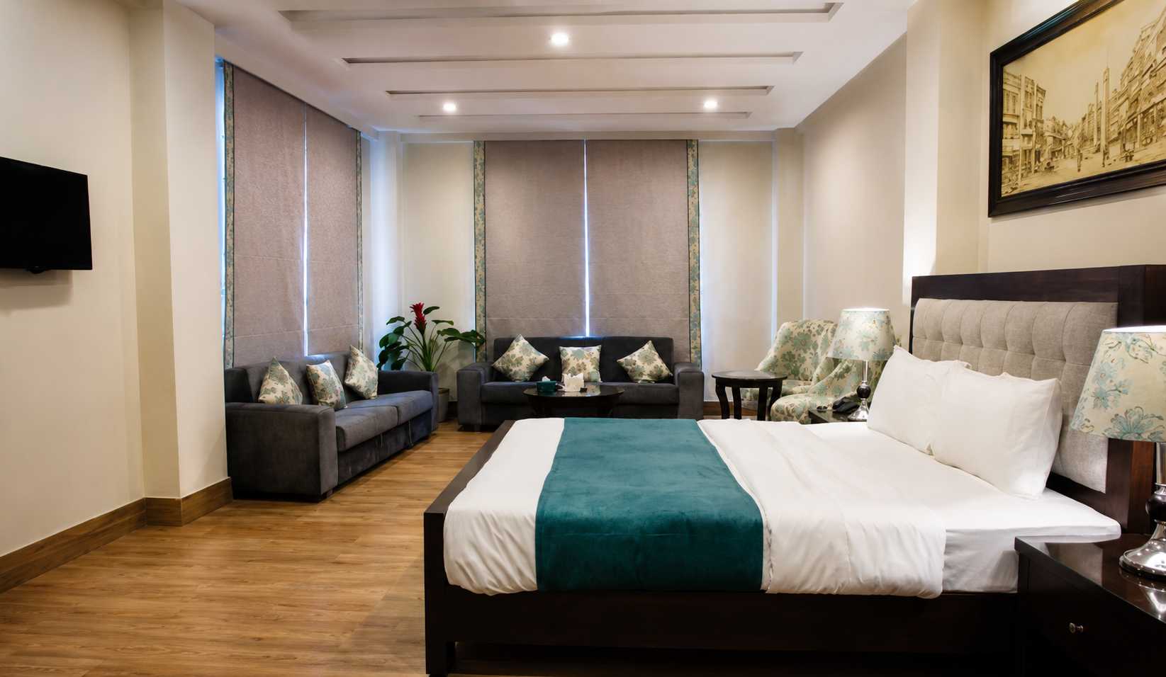 Comfortable luxury room with king bed, cozy sofas, and a welcoming atmosphere for travelers